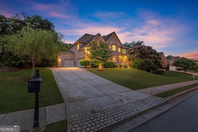 979 Pathview Ct, Dacula, GA 30019 - traditional home with driveway, a front yard, an attached garage, and brick siding