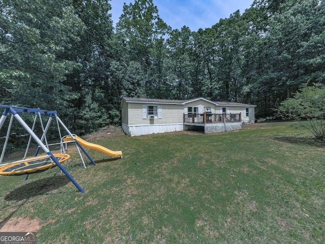 108 Casual Ridge Run, Jasper, GA 30143 - view of green lawn featuring a playground, a deck, and a view of trees