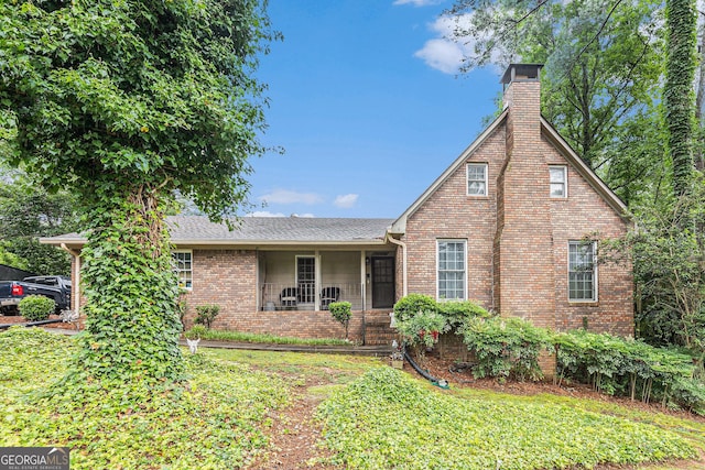 6230 S Summers Cir, Douglasville, GA 30135 - view of front of property featuring a chimney, a front lawn, brick siding, and roof with shingles