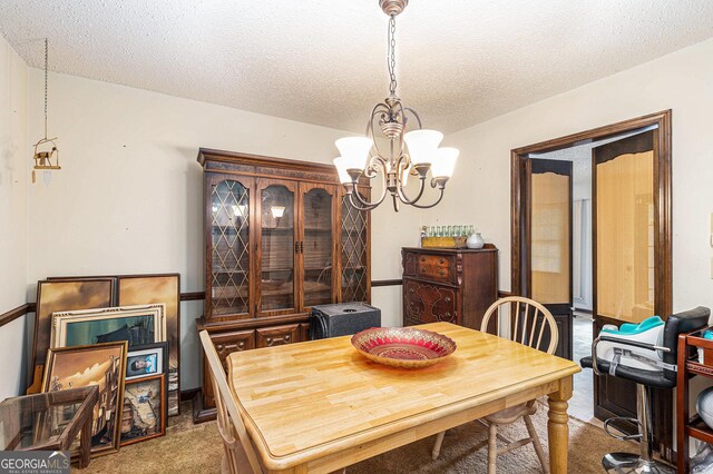 6230 S Summers Cir, Douglasville, GA 30135 - dining room featuring carpet flooring, a chandelier, and a textured ceiling