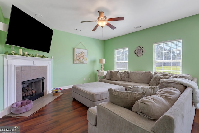 17 Sagefield Dr, Ellabell, GA 31308 - living area with ceiling fan, wood finished floors, a tiled fireplace, and baseboards