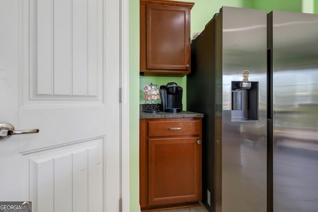 17 Sagefield Dr, Ellabell, GA 31308 - kitchen featuring stainless steel fridge with ice dispenser, dark countertops, and brown cabinets
