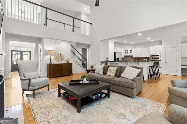 1860 Hill Chase, Alpharetta, GA 30022 - living room featuring a high ceiling, stairs, light wood-style floors, and recessed lighting