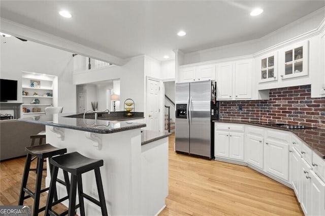 1860 Hill Chase, Alpharetta, GA 30022 - kitchen with stainless steel refrigerator with ice dispenser, open floor plan, a kitchen bar, white cabinets, and ornamental molding