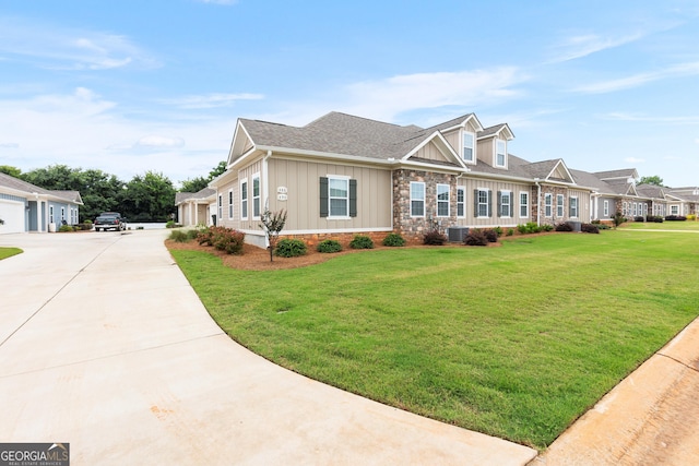 488 Nandina Ct, Warner Robins, GA 31088 - view of front of home featuring board and batten siding, a front lawn, a shingled roof, and driveway