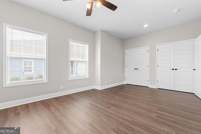 488 Nandina Ct, Warner Robins, GA 31088 - unfurnished bedroom with dark wood-type flooring, multiple closets, a ceiling fan, and recessed lighting