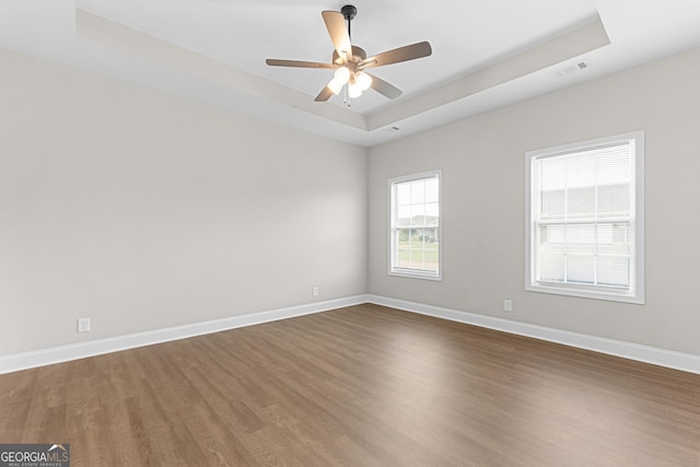 488 Nandina Ct, Warner Robins, GA 31088 - spare room with a tray ceiling, wood finished floors, and a ceiling fan