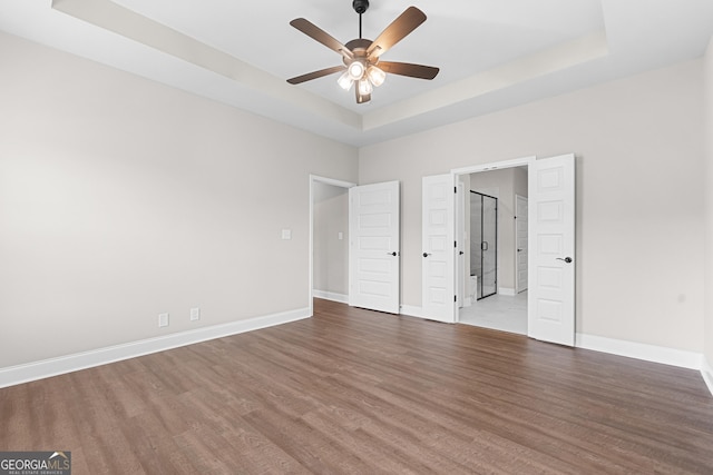 488 Nandina Ct, Warner Robins, GA 31088 - unfurnished bedroom featuring a raised ceiling, wood finished floors, and ceiling fan