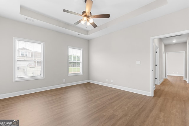 488 Nandina Ct, Warner Robins, GA 31088 - spare room with a tray ceiling, wood finished floors, and ceiling fan