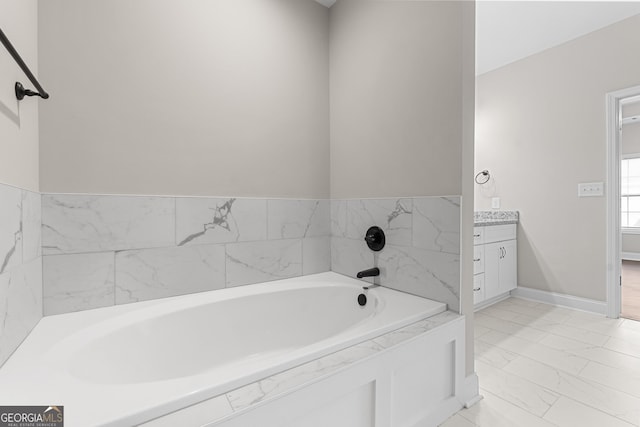 488 Nandina Ct, Warner Robins, GA 31088 - bathroom with marble look tile flooring, a garden tub, and vanity
