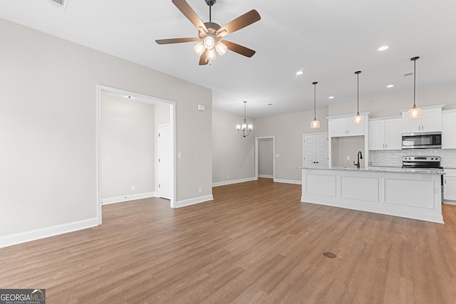 488 Nandina Ct, Warner Robins, GA 31088 - unfurnished living room featuring recessed lighting, ceiling fan, light wood-style flooring, and a chandelier