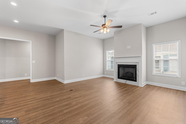 488 Nandina Ct, Warner Robins, GA 31088 - unfurnished living room featuring wood finished floors, a ceiling fan, recessed lighting, and a fireplace