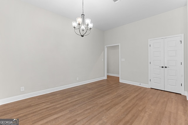 488 Nandina Ct, Warner Robins, GA 31088 - unfurnished room with a chandelier and light wood finished floors