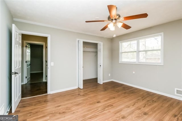 5798 Salem Rd, Covington, GA 30016 - unfurnished bedroom featuring light wood-style floors, baseboards, a ceiling fan, and a closet