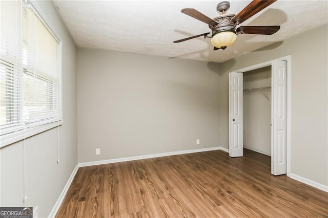 5798 Salem Rd, Covington, GA 30016 - unfurnished bedroom with wood finished floors, baseboards, ceiling fan, and a closet