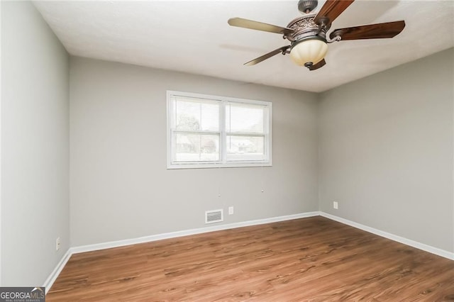5798 Salem Rd, Covington, GA 30016 - empty room with wood finished floors, baseboards, and ceiling fan