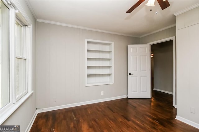 5798 Salem Rd, Covington, GA 30016 - unfurnished bedroom featuring dark wood-style flooring, crown molding, multiple windows, and baseboards