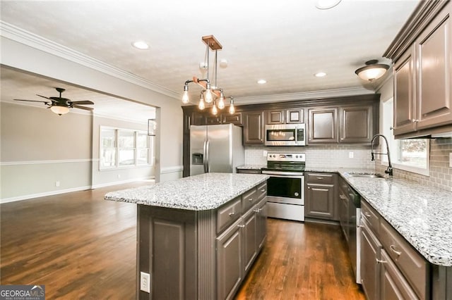 5798 Salem Rd, Covington, GA 30016 - kitchen with stainless steel appliances, a sink, decorative backsplash, light stone counters, and a center island
