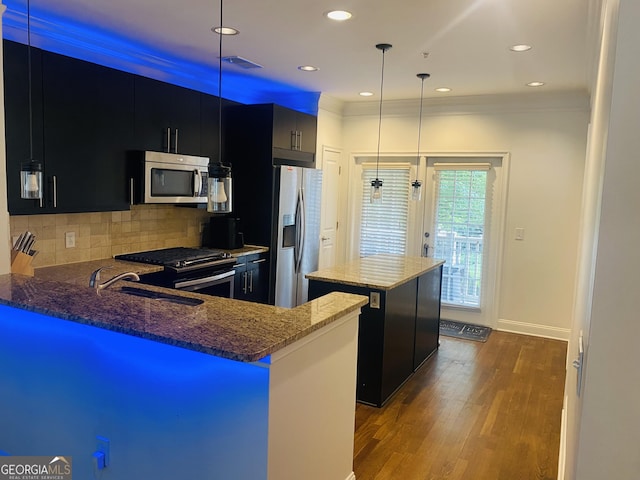 241 Perimeter Walk, Atlanta, GA 30338 - kitchen with appliances with stainless steel finishes, dark cabinetry, a kitchen island, wood finished floors, and a sink