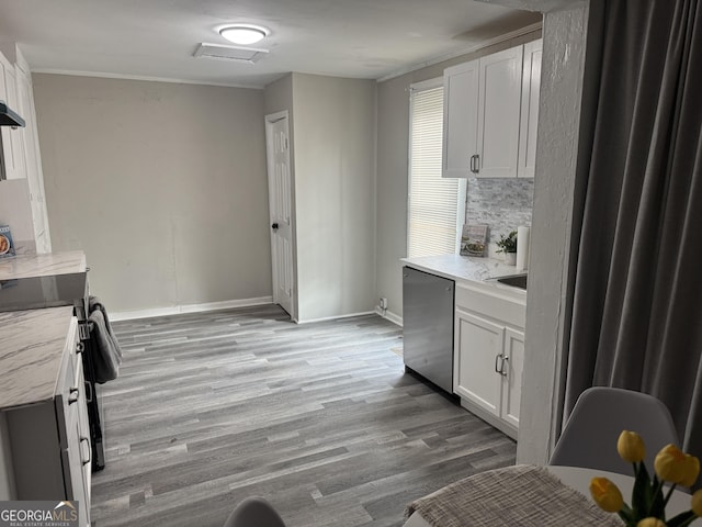 212 W Quilly St, Griffin, GA 30223 - kitchen featuring stainless steel appliances, light countertops, light wood-type flooring, white cabinets, and baseboards
