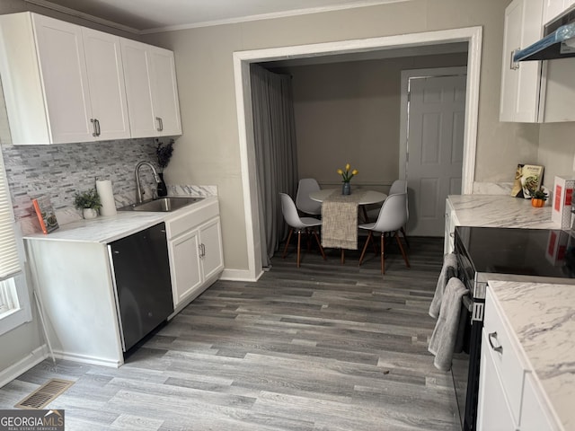 212 W Quilly St, Griffin, GA 30223 - kitchen featuring a sink, dishwasher, under cabinet range hood, electric range, and backsplash