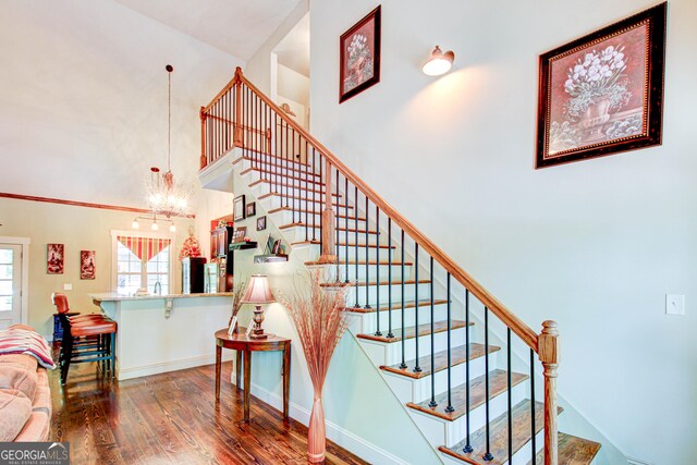 496 Cedar Valley Dr, Wedowee, AL 36278 - stairs with wood finished floors, a chandelier, and a high ceiling