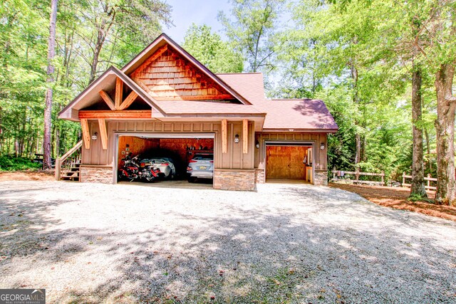 496 Cedar Valley Dr, Wedowee, AL 36278 - view of front facade with board and batten siding, roof with shingles, driveway, and an attached garage