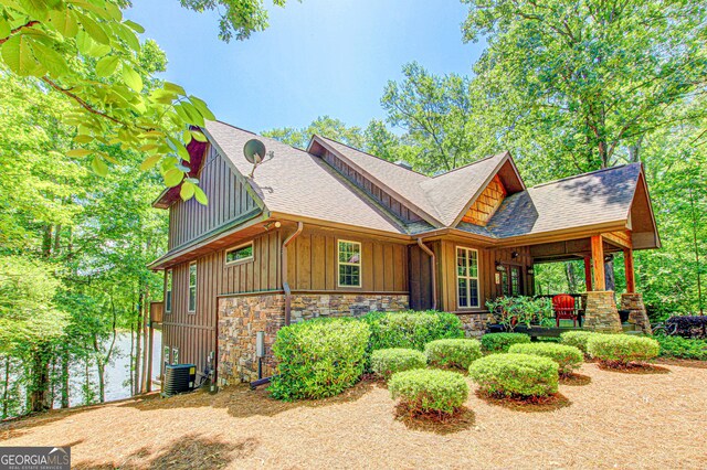 496 Cedar Valley Dr, Wedowee, AL 36278 - view of front of home featuring board and batten siding, roof with shingles, stone siding, and a porch