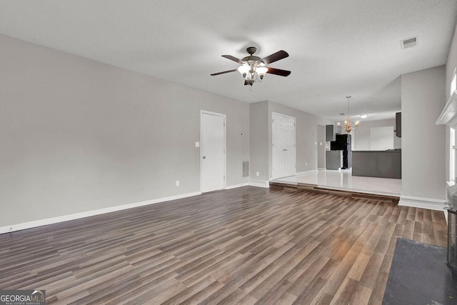 3885 Riverview Chase Blf, Ellenwood, GA 30294 - unfurnished living room with a chandelier, a ceiling fan, dark wood-style floors, baseboards, and a textured ceiling