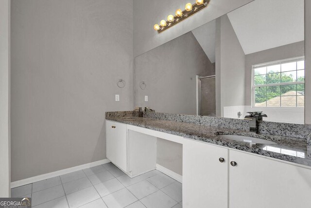 3885 Riverview Chase Blf, Ellenwood, GA 30294 - bathroom featuring double vanity, a shower stall, tile patterned floors, baseboards, and vaulted ceiling