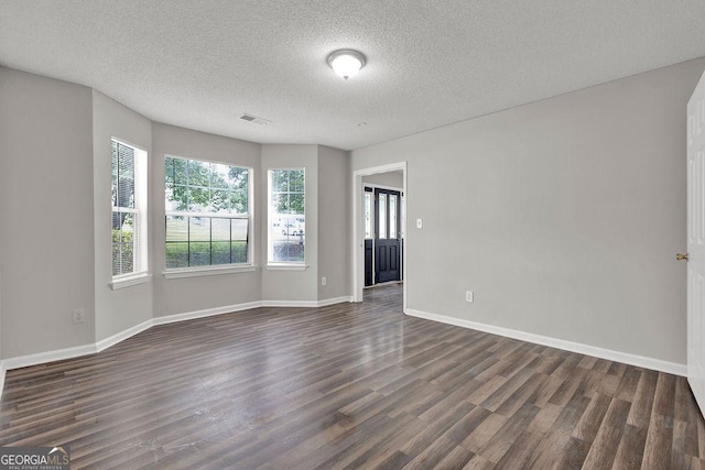 3885 Riverview Chase Blf, Ellenwood, GA 30294 - spare room featuring dark wood finished floors, a textured ceiling, and baseboards