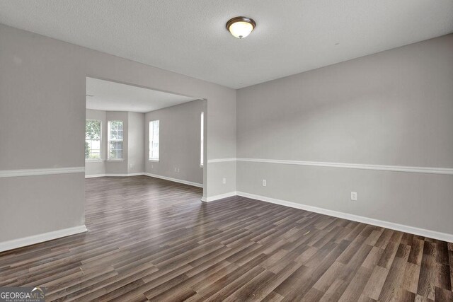 3885 Riverview Chase Blf, Ellenwood, GA 30294 - empty room with dark wood-style flooring and baseboards