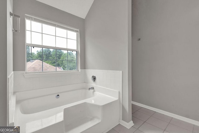 3885 Riverview Chase Blf, Ellenwood, GA 30294 - full bathroom with a garden tub, tile patterned flooring, vaulted ceiling, and baseboards