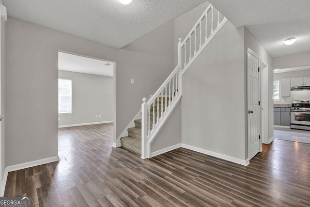 3885 Riverview Chase Blf, Ellenwood, GA 30294 - stairs with wood finished floors, a textured ceiling, plenty of natural light, and baseboards