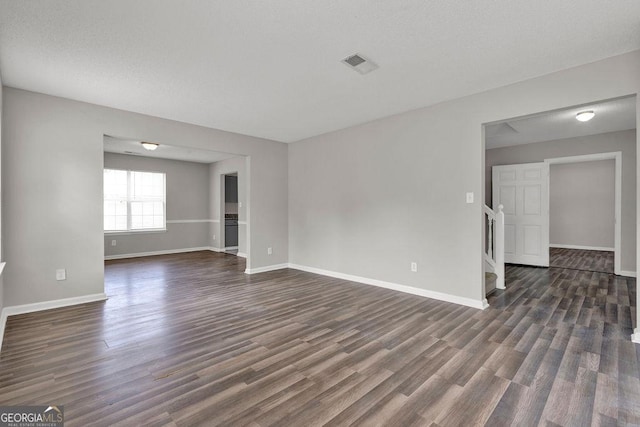 3885 Riverview Chase Blf, Ellenwood, GA 30294 - spare room with dark wood-type flooring, baseboards, and stairs