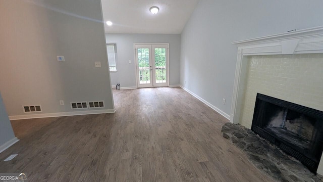 5710 Cardigan Trce, Sugar Hill, GA 30518 - unfurnished living room featuring wood finished floors, baseboards, a brick fireplace, and vaulted ceiling