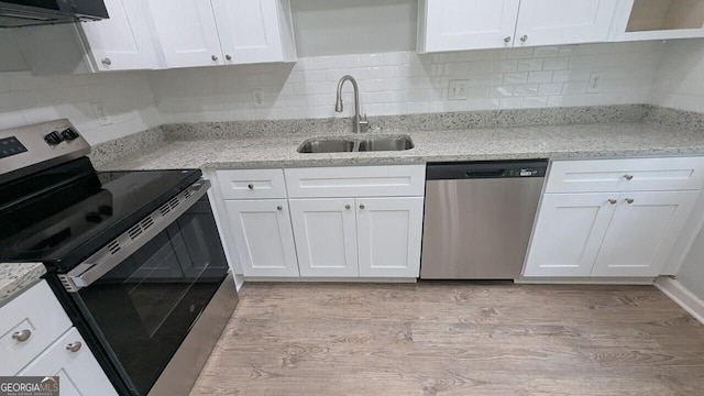 5710 Cardigan Trce, Sugar Hill, GA 30518 - kitchen with appliances with stainless steel finishes, a sink, under cabinet range hood, white cabinets, and light wood-style floors