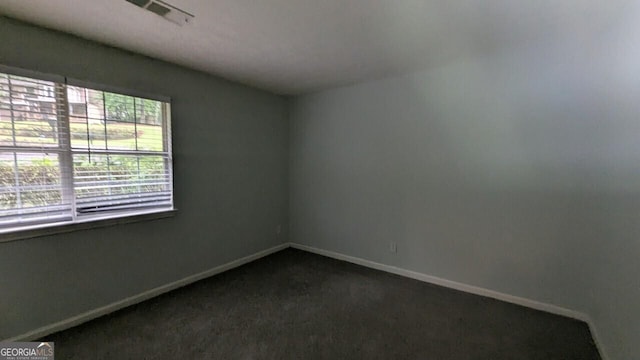 5710 Cardigan Trce, Sugar Hill, GA 30518 - empty room with healthy amount of natural light, baseboards, and dark colored carpet