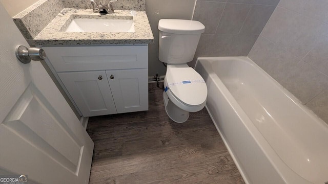 5710 Cardigan Trce, Sugar Hill, GA 30518 - full bathroom with toilet, wood finished floors, a tub, and vanity