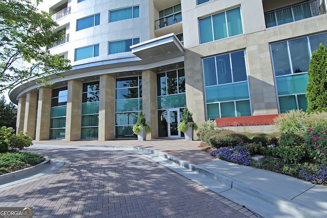 4561 Olde Perimeter Way Unit 608, Dunwoody, GA 30346 - view of exterior entry featuring stone siding