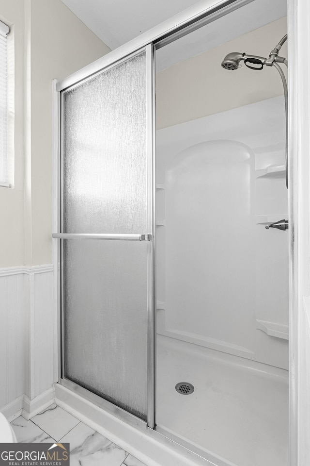 202 Kimberly Rd, Warner Robins, GA 31088 - full bathroom with a shower stall, marble look tiles, and wainscoting