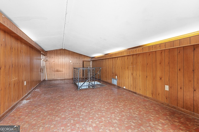 202 Kimberly Rd, Warner Robins, GA 31088 - empty room with lofted ceiling, wood walls, and baseboards
