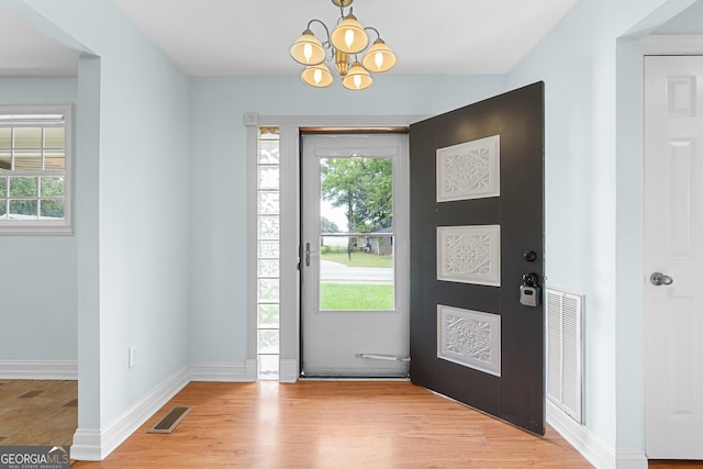 202 Kimberly Rd, Warner Robins, GA 31088 - foyer featuring a chandelier, healthy amount of natural light, baseboards, and light wood-type flooring