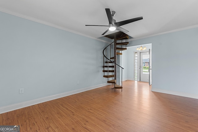 202 Kimberly Rd, Warner Robins, GA 31088 - spare room with stairway, ornamental molding, wood finished floors, ceiling fan, and baseboards
