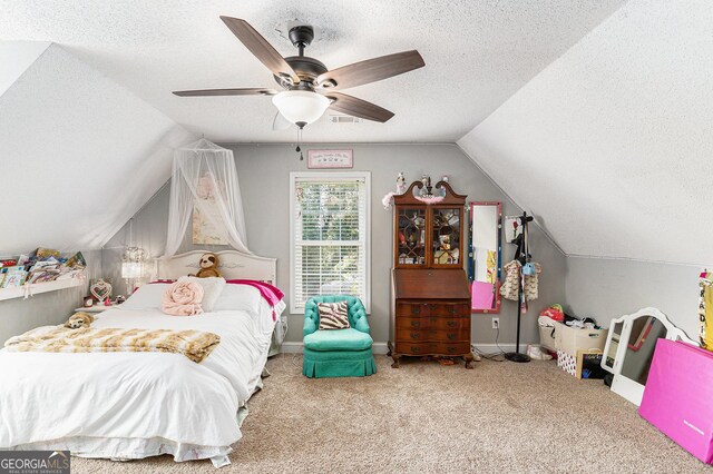 1112 Sutton Dr, Mcdonough, GA 30252 - carpeted bedroom featuring a textured ceiling, lofted ceiling, and a ceiling fan