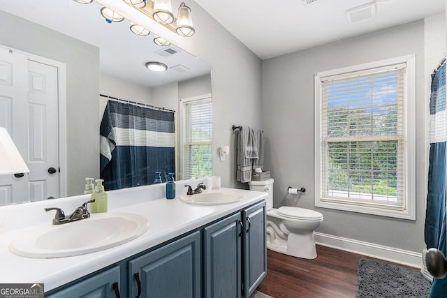 1112 Sutton Dr, Mcdonough, GA 30252 - bathroom with double vanity, wood finished floors, and curtained shower