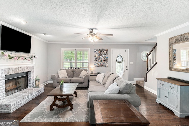 1112 Sutton Dr, Mcdonough, GA 30252 - living area with ceiling fan, stairs, dark wood-style flooring, ornamental molding, and a textured ceiling
