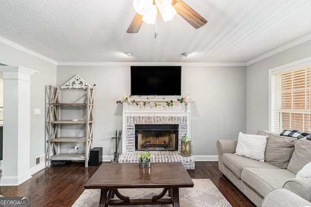 1112 Sutton Dr, Mcdonough, GA 30252 - living room featuring wood finished floors, a ceiling fan, crown molding, a fireplace, and a textured ceiling