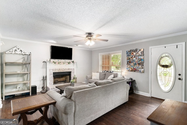 1112 Sutton Dr, Mcdonough, GA 30252 - living room featuring a ceiling fan, dark wood finished floors, crown molding, a fireplace, and a textured ceiling
