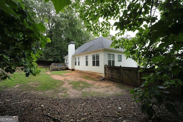 262 Devynwood Ln, Dallas, GA 30157 - rear view of house featuring a wooden deck, a chimney, and roof with shingles